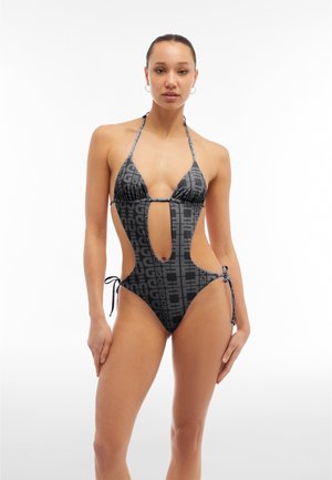 Black and gray swimsuit featuring a halter neck, cutout sides, and ties at the hips, with a repeating logo pattern throughout.