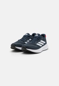Navy blue athletic shoes with white stripes, mesh upper, textured sole, and red heel accent. Lightweight design suitable for running.