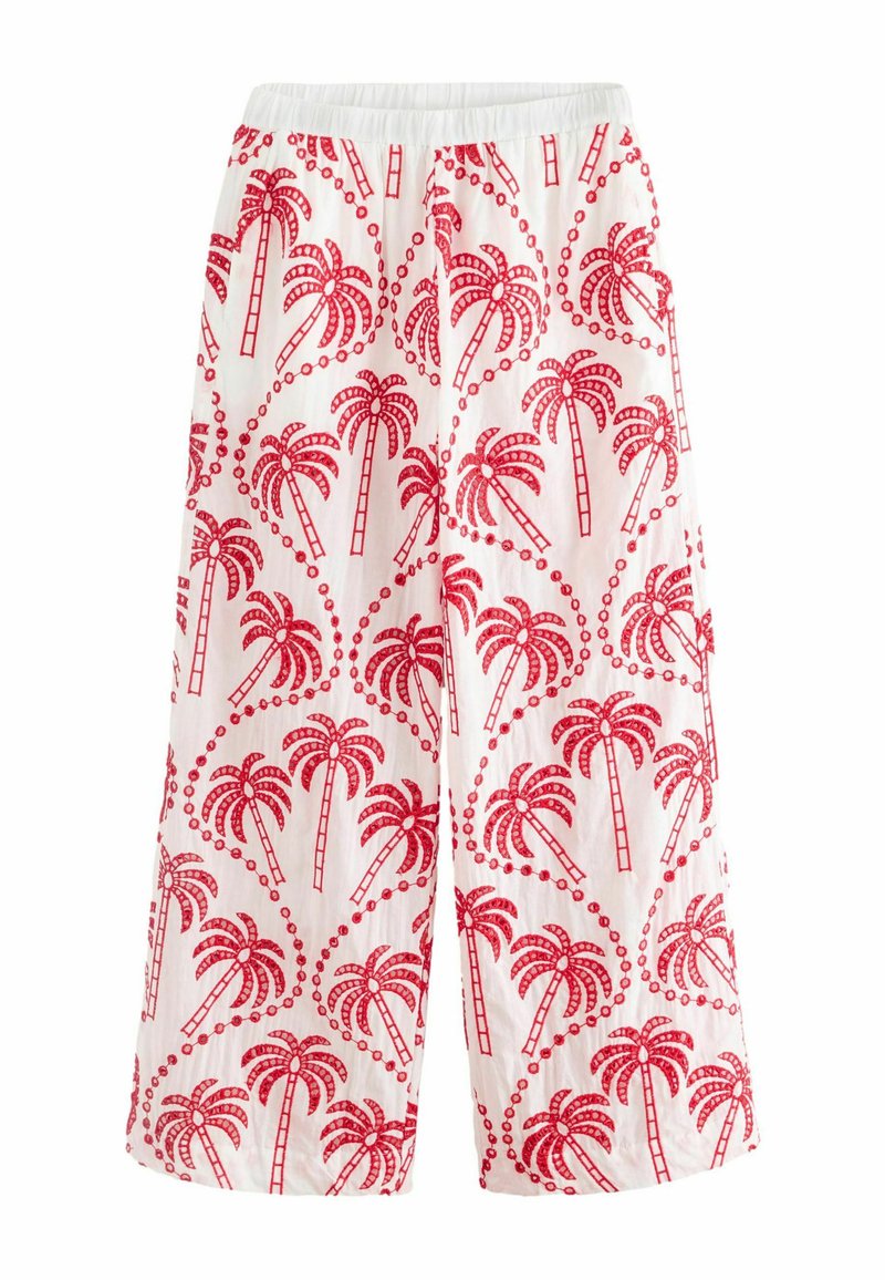 Bomulds cropped bukser med elastisk talje, prydet med et rødt palmetrædesign på hvid baggrund, med cirkulære detaljer spredt over det hele.