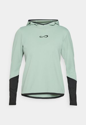Maglione a maniche lunghe verde chiaro con cappuccio e maniche a contrasto nere. Tessuto texturizzato con un piccolo simbolo dell'infinito nero sul petto.