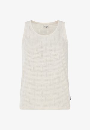 Débardeur blanc en tissu texturé avec un motif à carreaux. Il a un col rond et pas de manches, avec une petite étiquette de marque sur le côté.