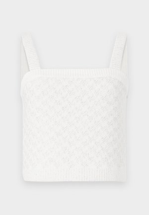 Hvit strikket topp med rektangulær halslinje, med teksturerte mønstre og brede ribbede stropper. Mykt stoff med subtil glans.