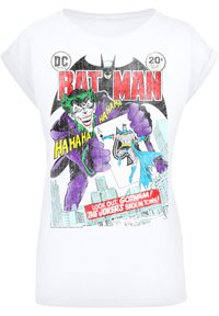 Valge T-särk, millel on koomiksistiilis print Batmanist ja Jokerist. Graafika sisaldab erksaid värve, teksti ja linna silueti detaile.