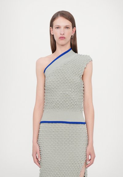 Top de punto ligero gris claro con un solo hombro que presenta escamas texturizadas, un cuello de canalé azul y una silueta ajustada con una abertura lateral.
