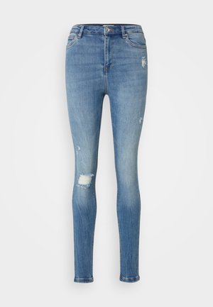 Skinny blue denim jeans with a faded wash, featuring distressed details, a mid-rise waist, and front pockets. Classic five-pocket design.