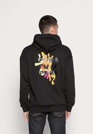 Black hoodie with a large, colorful, dripping graphic on the back featuring the brand name "PUMA" in various colors and textures.