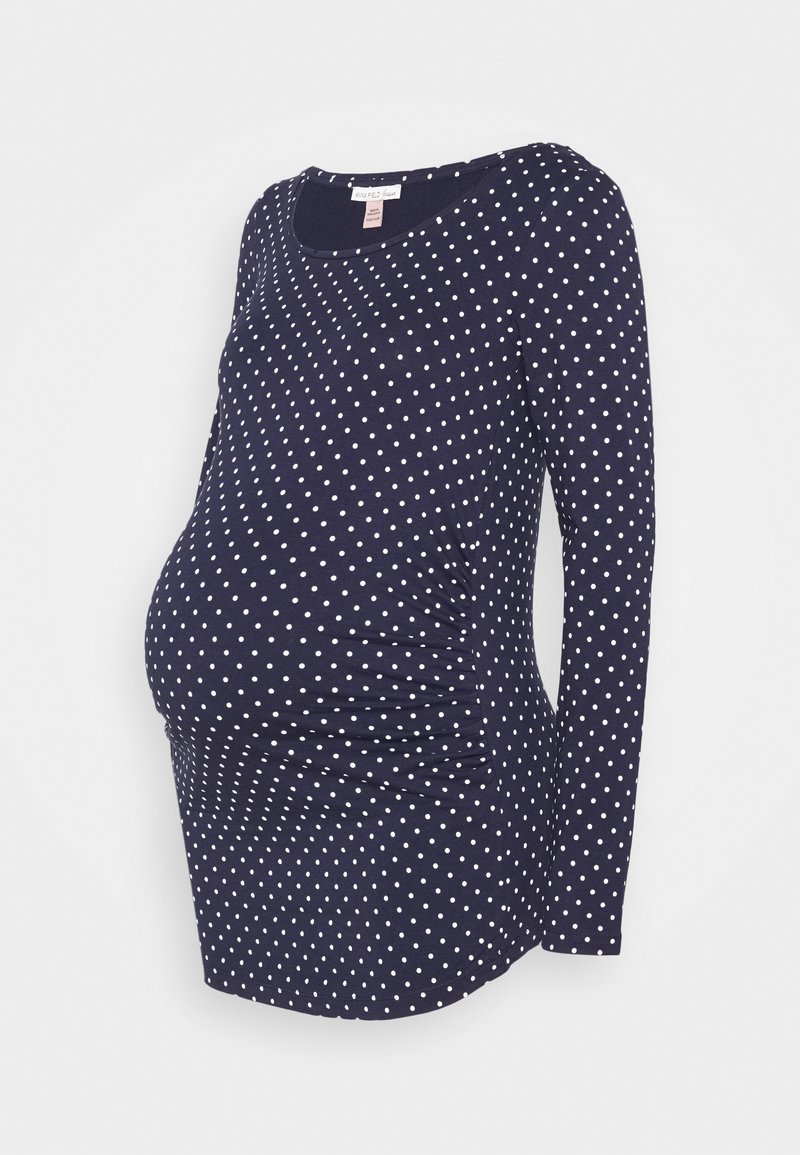 Tmavě modrá těhotenská halenka s dlouhým rukávem, bílými puntíky, na stranách nařasená a s kulatým výstřihem.