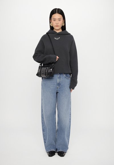 Gray hooded sweatshirt with front pocket, wide-leg light blue jeans, and a black purse with textured accents, paired with black shoes.