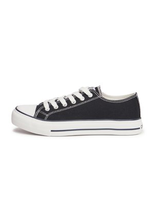 Black canvas sneaker with white rubber sole, white laces, and contrasting stitching. Classic low-top design with a rounded toe.