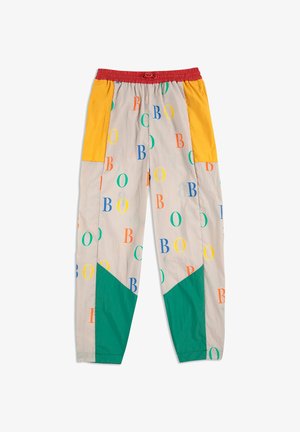 Colorful patterned pants made of lightweight fabric. Features an elastic waistband, multicolored sections in yellow, green, and red, with letters.