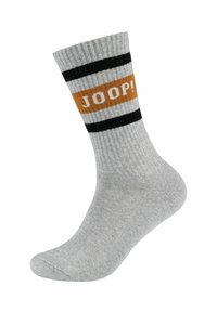Grå ribbet sok med sort og hvid striber; har et orange bånd med "JOOP!" tekst i hvid. Glat tekstur, ankellængde.