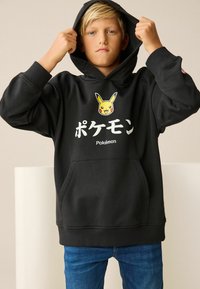 Black hoodie with a front kangaroo pocket, featuring a Pikachu graphic and "ポケモン" text in white. Simple design with ribbed cuffs.