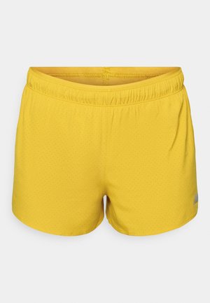 Gula sportshorts i ett lätt och ventilerande material, med en perforerad textur och elastisk midja; logotypdetalj på sidan.
