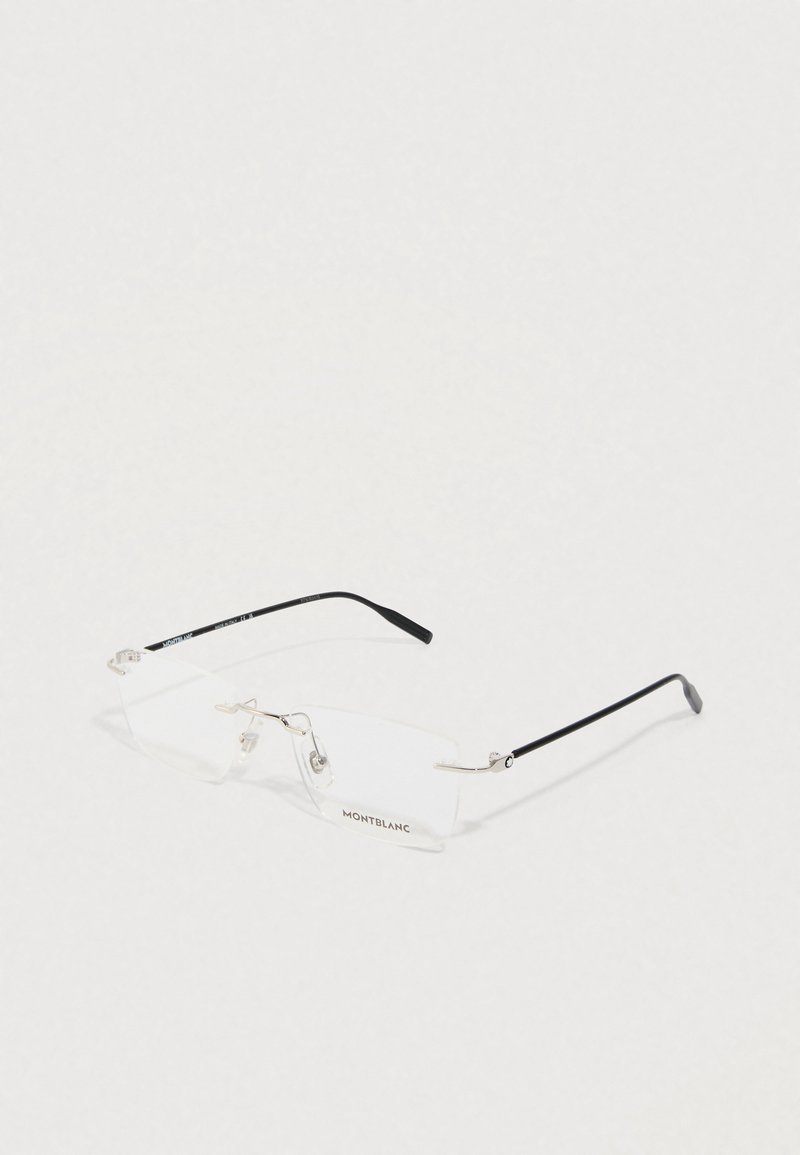 Rimless ristkülikukujulised Montblanc prilliraamid, õhukeste mustade tempedega ja läbipaistvate nina toestustega valgel pinnal.