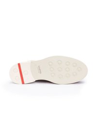 Suola della scarpa con una superficie in gomma bianca liscia, caratterizzata da modelli di texture circolari e una striscia rossa di accento. Nome del marchio "LLOYD" impresso.