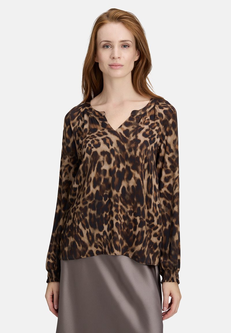 Langärmlige Bluse mit Leopardenmuster in Braun und Schwarz, V-Ausschnitt und elastischen Bündchen, aus leichtem Stoff, leicht lockere Passform.