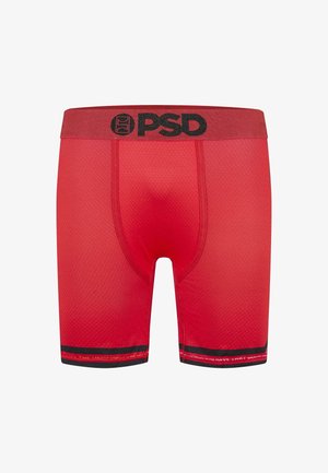 Boxer-culottes rouges en tissu texturé, dotées d'une large taille élastique avec le logo "PSD" en noir et d'une bordure contrastante noire au niveau de l'ourlet.