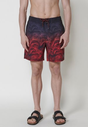 Heren zwembroek met een zwart naar rood verloop en palmenpatronen. Gemaakt van lichte stof met een tailleband met trekkoord.