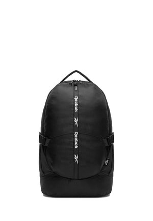 Černý batoh Reebok s předním vertikálním zipem, logem Reebok, bočními nastavovacími pásky a horním madlem, zobrazený na bílém pozadí.