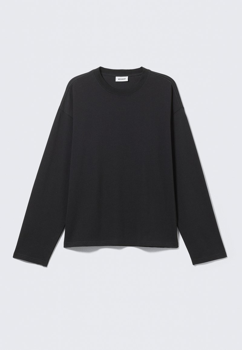 Long-sleeve black crewneck shirt with dropped shoulders and a small brand label at the neckline, displayed on a plain light background.
