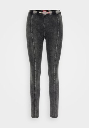 Leggings in denim nero con una vita alta, vestibilità slim e cuciture a contrasto. La superficie presenta una finitura sbiadita e testurizzata.