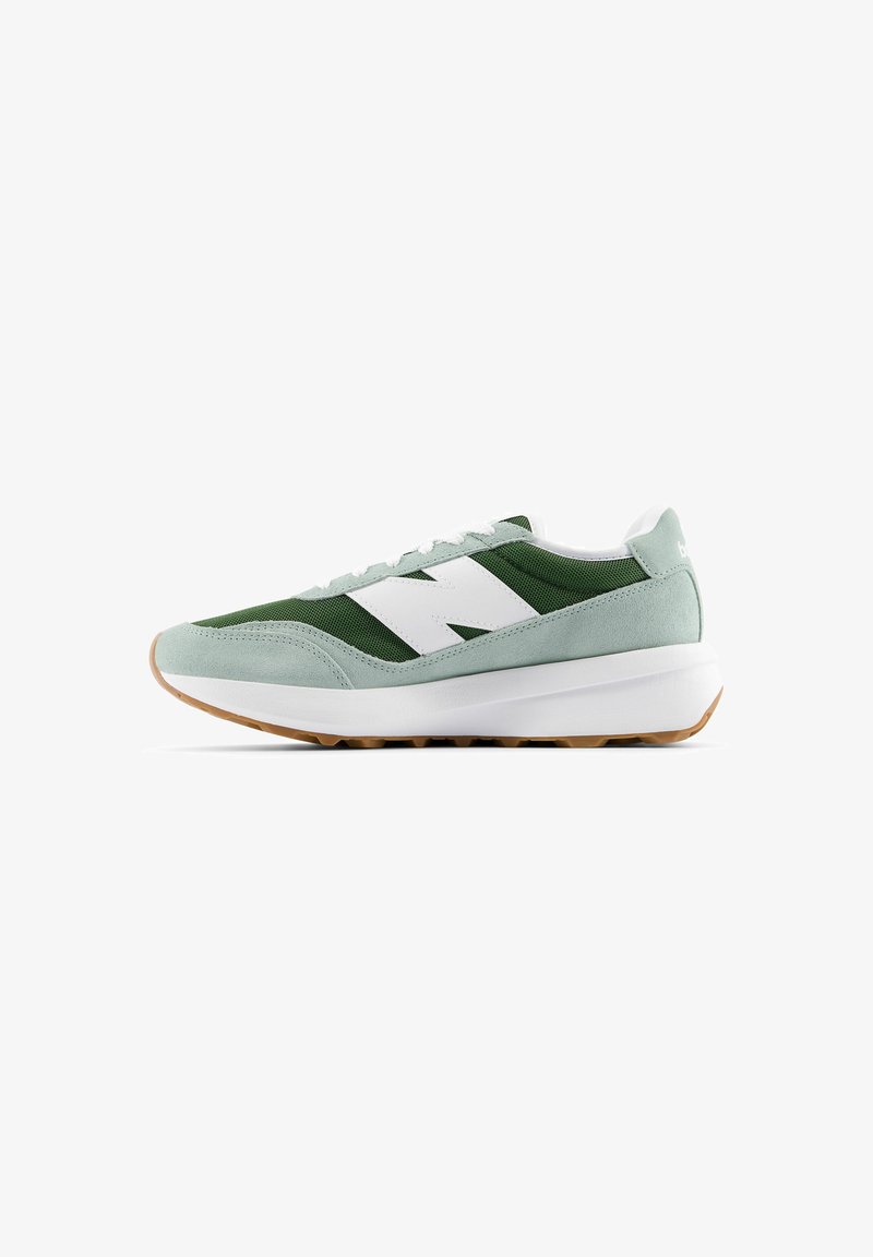 Green and white sneaker featuring a suede and mesh upper, rounded toe, white logo, and a gum rubber outsole. Laces and padded collar included.