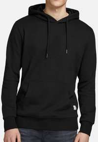 Black hoodie featuring a front pocket, adjustable drawstring hood, ribbed cuffs, and hem, made from soft, stretchy fabric.