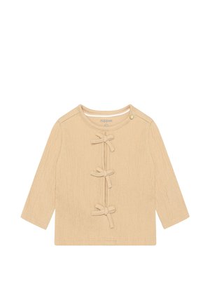 Beige top met lange mouwen, gemaakt van gestructureerde stof en met drie strikaccenten aan de voorkant, voorzien van een ronde halslijn en drukknoopsluiting.