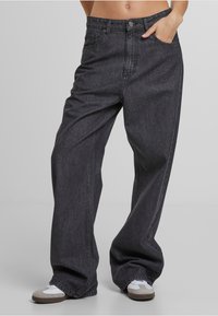 Vide benbukser i mørk grå denim med knaplukning, forlommer og en glat tekstur. Casual design med en afslappet pasform.