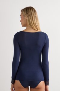 Navy long-sleeve top with lace accents at the cuffs. Smooth, fitted design, with a crew neckline and soft texture.