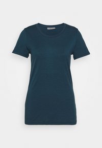Mörk teal kortärmad t-shirt med rund hals. Tillverkad av mjukt tyg, med en enkel design och rak kant.