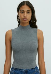 Gray ribbed crop top with a high neckline and sleeveless design. Fabric appears soft with a form-fitting silhouette.
