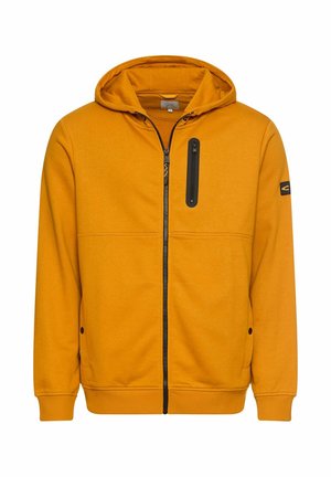Haut à capuche orange zippé, avec une poche poitrine zippée noire et des poches latérales, fabriqué à partir d'un tissu lisse et léger.