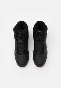 Svarta hög-top sneakers gjorda av läder med en texturerad yta, har fuskpälsfoder, perforerat tårum och platta snörningar.