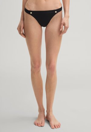 Zwarte bikini slip met een slank ontwerp, voorzien van gouden accenten aan de zijkanten, een gladde textuur en een lage snit.