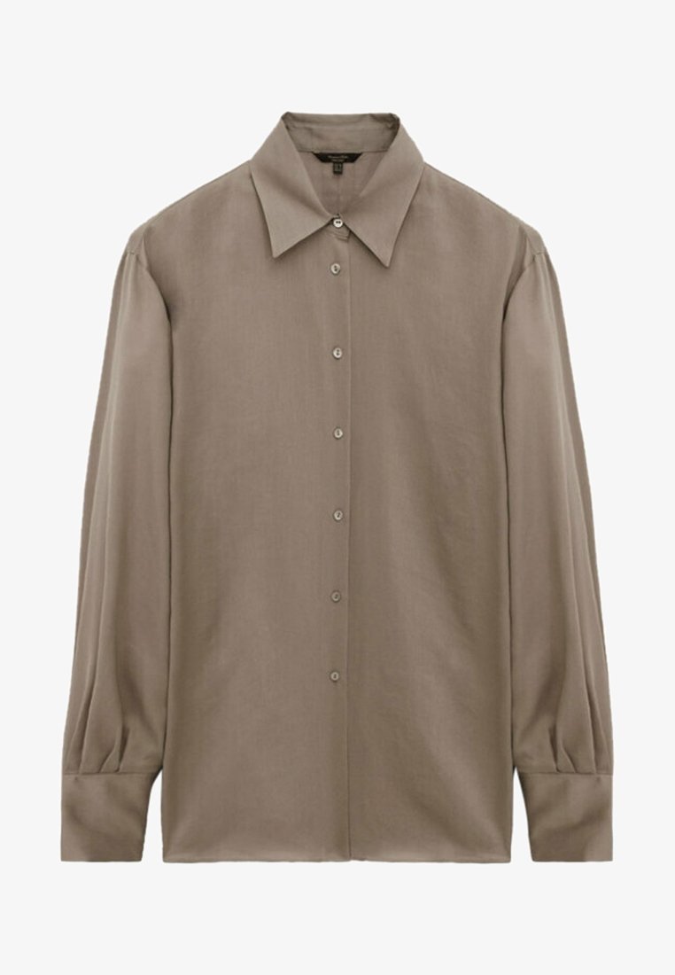 Chemise beige à manches longues avec boutons, col large et poignets ajustés, présentée à plat sur fond blanc.