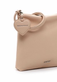 Beige leather handbag with a textured finish, featuring a heart-shaped tag with "EMILY&NOAH" engraved, adjustable handle, and minimalist design.