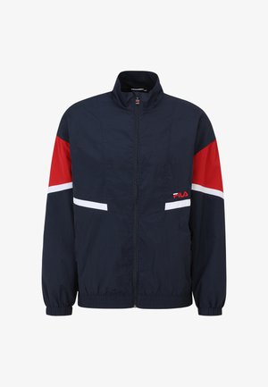 Chaqueta cortavientos de la marina con detalles en rojo y blanco, cuello alto, cremallera completa, puños elásticos y bolsillos laterales. Logo de Fila en el pecho.