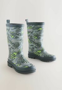 Gray waterproof rubber boots feature a camouflage pattern with green accents and a textured sole for grip. Includes pull tabs for easy wear.