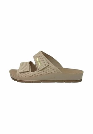 Sandalo slip-on beige con due cinturini regolabili e suola imbottita, progettato per il comfort e un uso casual.