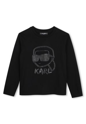 Chemise noire à manches longues avec un graphisme texturé d’un visage portant des lunettes de soleil et le mot "KARL" en dessous, au centre devant.