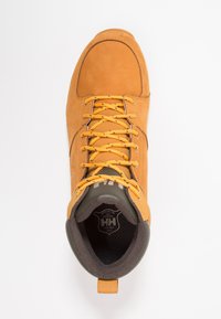 Bruine leren wandelschoen met oranje veters, ronde neus, gevoerde binnenkant en een contrasterende zwarte en grijze voering.