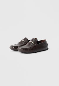 Brown leather loafers with a textured finish, featuring a silver accent band and a low profile sole for comfort and ease of wear.