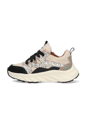 Sneaker featuring a beige upper with silver glitter accents, black suede overlays, textured tan heel, and a thick white sole with a patterned tread.