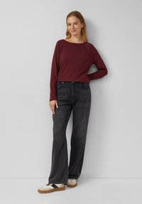 Burgundi värvi pika varrukaga särk, millele on sobitatud kõrge vöökohaga laiad mustad teksad ja kreemivärvi tossud tumedate aktsentidega. Sujuv kangas, mugav lõige.