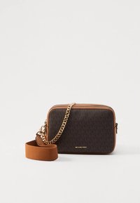 Brown crossbody bag with gold chain and adjustable fabric strap, featuring Michael Kors logo on the front against a plain background.