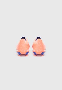 Pair of orange and blue soccer cleats shown from the back on a plain light background, featuring small triangular patterns.