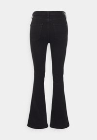 Jeans de campana negros hechos de denim con una textura suave. Cuenta con dos bolsillos traseros y una cinturilla estándar. Vista trasera mostrada.