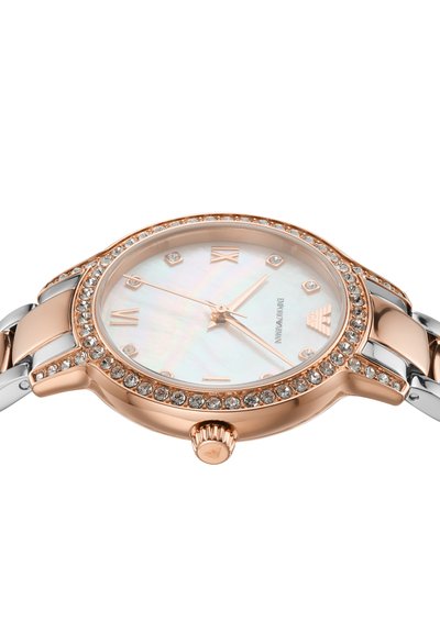 Rose gold-tone watch with a mother-of-pearl dial, Roman numerals, and crystal accents. Silver-tone and rose gold band. Round case design.