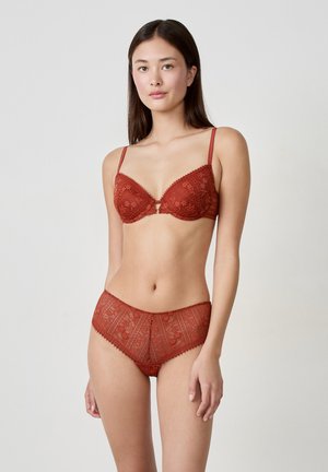 Red lace lingerie set featuring a balconette bra with adjustable straps and intricate floral patterns, paired with matching high-waisted briefs.